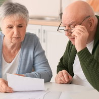 Couple checking mortgage paperwork at home in Spain