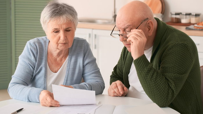 Couple checking mortgage paperwork at home in Spain