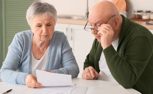 Couple checking mortgage paperwork at home in Spain
