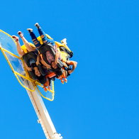 Two young women are upside down while riding a fair ride.