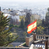 Spanish flag blowing in wind in Granada
