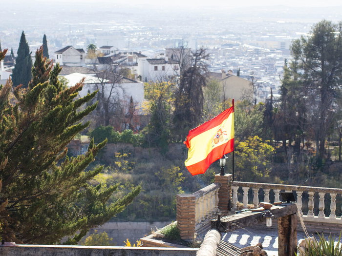 Spanish flag blowing in wind in Granada