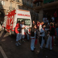 ambulances and doctors attending to injured people in the street