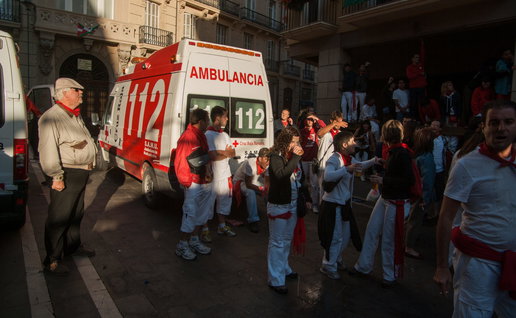 ambulances and doctors attending to injured people in the street