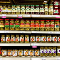 Several jars Of Pickled Olives on a grocery store shelf