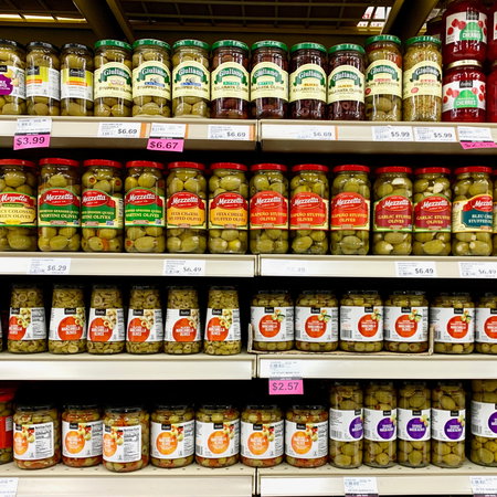 Several jars Of Pickled Olives on a grocery store shelf