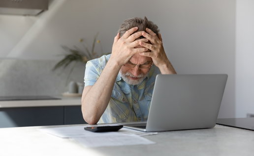 Man frustrated looking at his bank account
