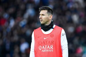 Football player Leo Messi warming up during a match 