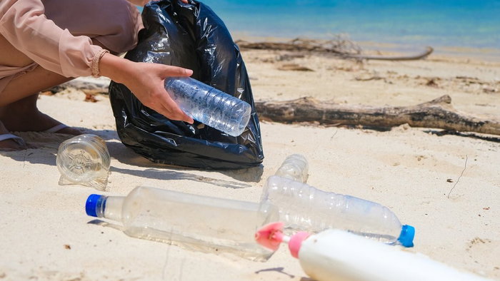 Collecting plastic bottles on the beach