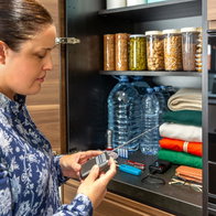 A woman checks her emergency kit and batteries in a radio