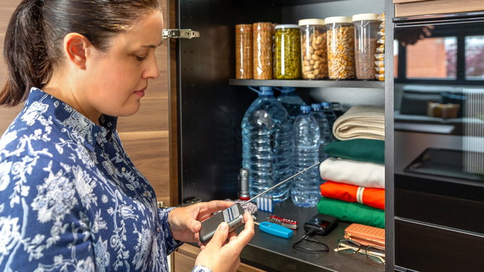 A woman checks her emergency kit and batteries in a radio