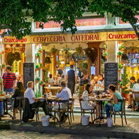Outdoor diners at night at the Bar Cerveceria Catedral, near Seville Cathedral, Spain
