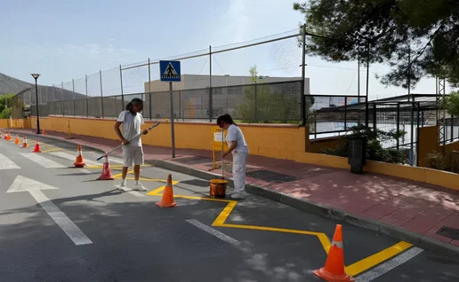 Workers putting finishing touches for school kids.
