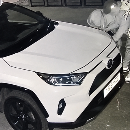 Thieves accessing electronics via headlight caught on security camera.