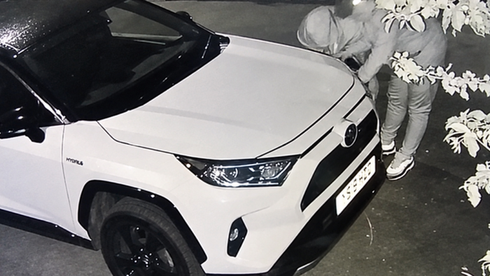 Thieves accessing electronics via headlight caught on security camera.