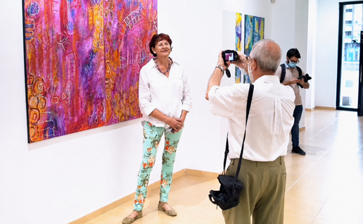 Birgitte standing in front of one of her works.
