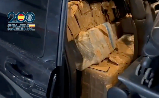 Bundles of cocaine wrapped in tape and stacked inside a car seat, photographed by Policía Nacional during a drugs raid.