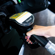 Person refuels at a petrol station using a Diesel pump.