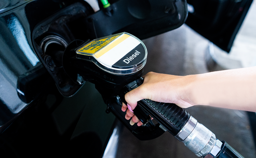 Person refuels at a petrol station using a Diesel pump.