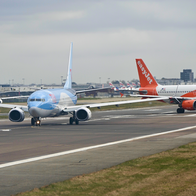 TUI and EasyJet aircrafts on the runway at Gatwick Airport.