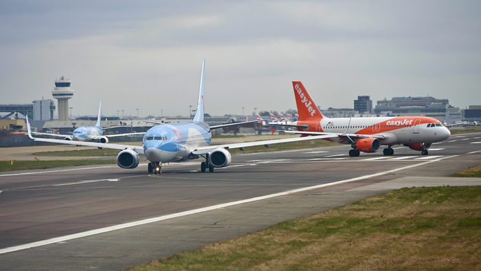 TUI and EasyJet aircrafts on the runway at Gatwick Airport.