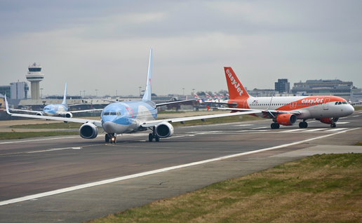 TUI and EasyJet aircrafts on the runway at Gatwick Airport.
