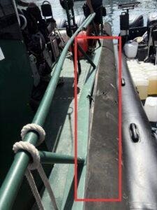 Guardia Civil boat pressed up against the drug trafficking speedboat, with the side of the official's boat damaged after the incident. 