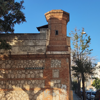Side façade of the old Málaga prison building in a Málaga neighbourhood.