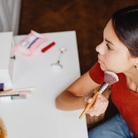 Young female applying makeup