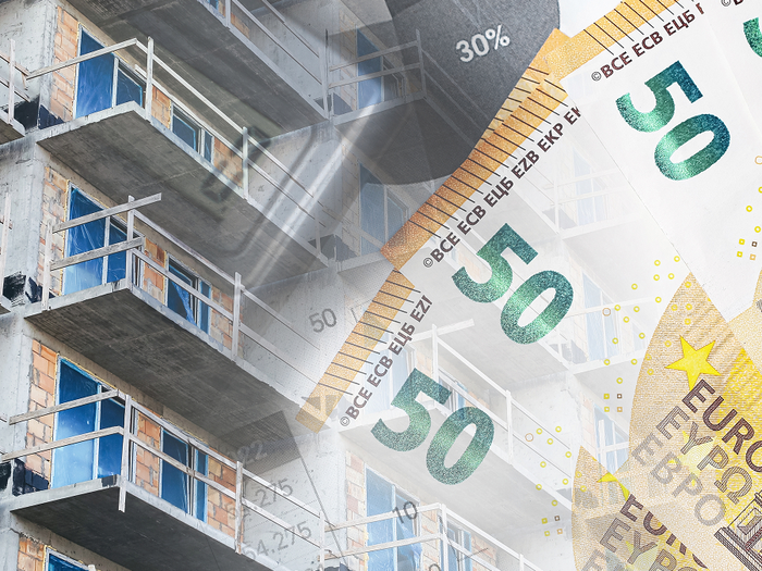A building under construction overlaid with €50 euro banknotes.