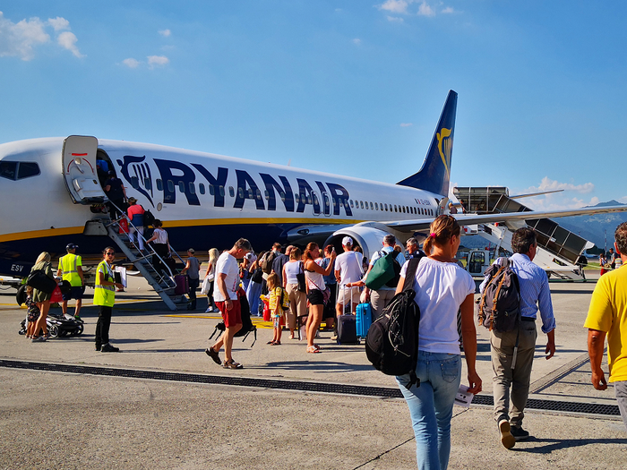A Ryanair aircraft on the tarmac as passengers make their way on to the airplane.