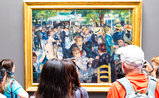 Tourists looking at a framed painting of Renoir