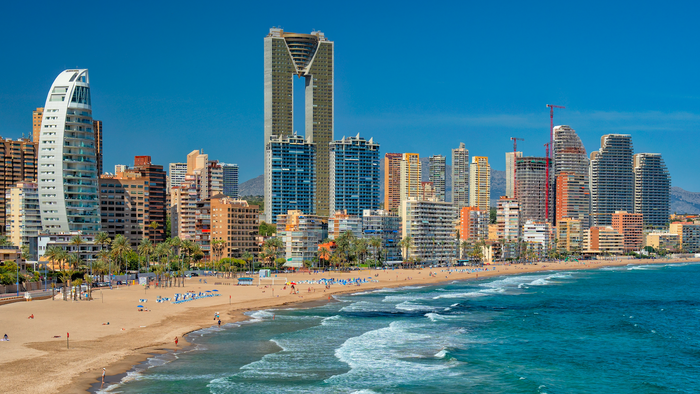 Beach front of Benidorm with hotels and apartment complexes behind the beach