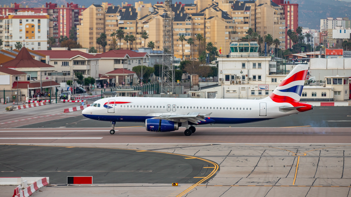 The runway at Gibraltar airport with a British Airways aircraft preparing to take off