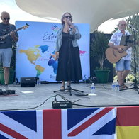 Sunset Flyers on stage with British and Spanish flags