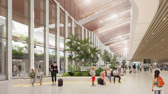 Architectural rendering of a bright, modern airport terminal interior with palm trees, glass walls and travellers with luggage, showing the planned redesign of Tenerife Sur airport's terminal.
