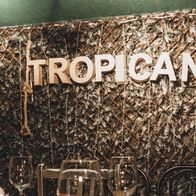 Large 'Tropicana' sign above a table in the restaurant where the dine-and-dash happened.