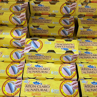 Stacked yellow multipacks of Spanish canned light tuna, each holding six 80g tins, in a supermarket display.