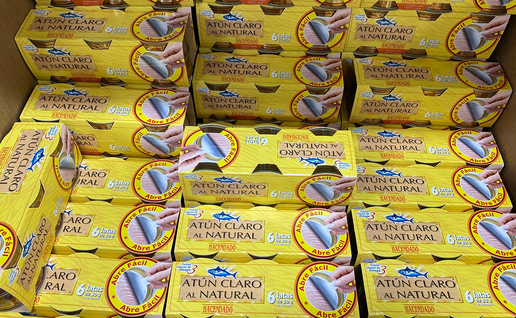Stacked yellow multipacks of Spanish canned light tuna, each holding six 80g tins, in a supermarket display.