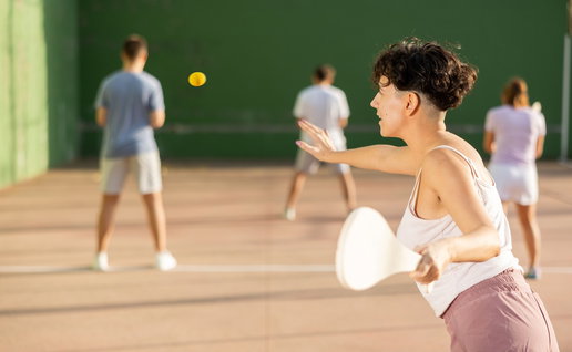 Woman playing Basque Pelota on an outdoor court