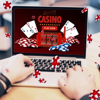 Online casino and gaming, gambling on device concept. Close up of male hands using laptop computer at workplace with creative slot machine and other games