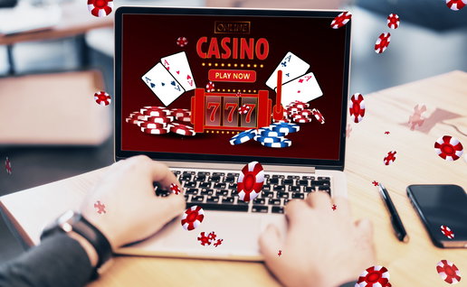 Online casino and gaming, gambling on device concept. Close up of male hands using laptop computer at workplace with creative slot machine and other games