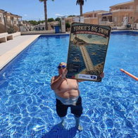 Royal Navy veteran completes gruelling 15km charity swim after battling knee injury.