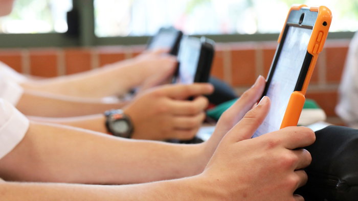 High school students using tablets in class