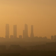 View of Madrid Business Area skyscrapers with air pollution during sunset