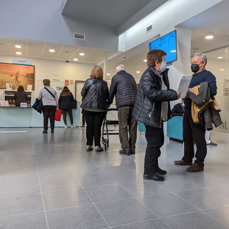 A queue at a reception desk at a health centre in Spain