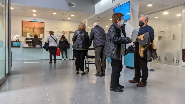 A queue at a reception desk at a health centre in Spain