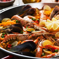 Closeup of spanish paella with shrimp and mussel in a pan.