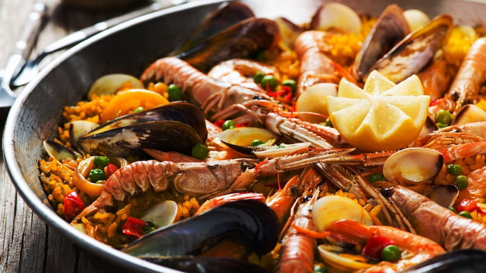 Closeup of spanish paella with shrimp and mussel in a pan.