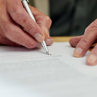 Signing a will.